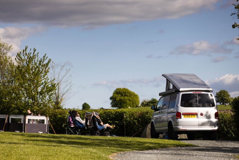 relaxing in a chair by campervan 768x513